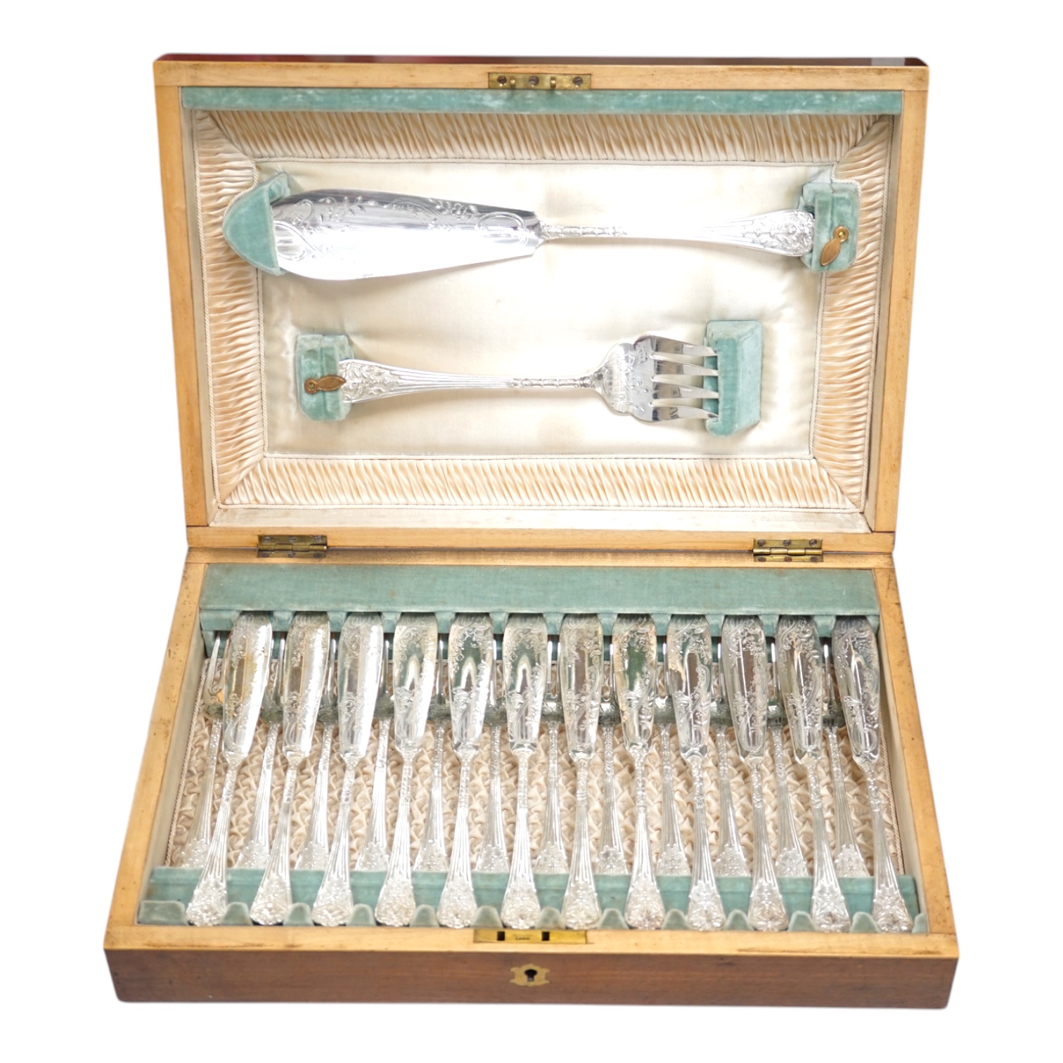 A set of twelve plated and engraved fish knives and forks, together with a pair of servers, housed in a mahogany case, 39cm wide. Condition - fair to good